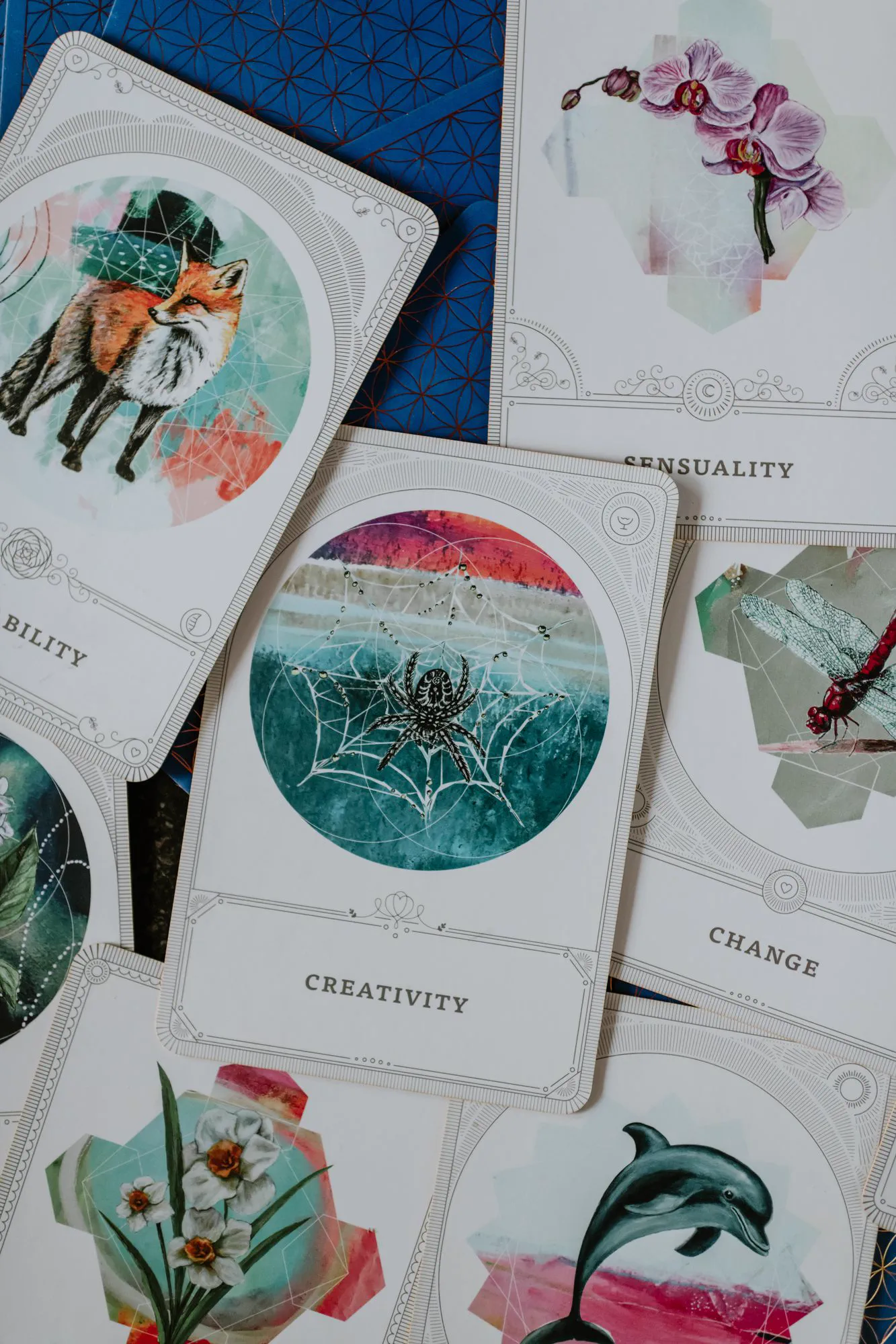 A spread of oracle and affirmation cards on a table.